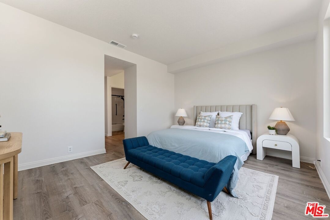 Bedroom featuring wood-style f
