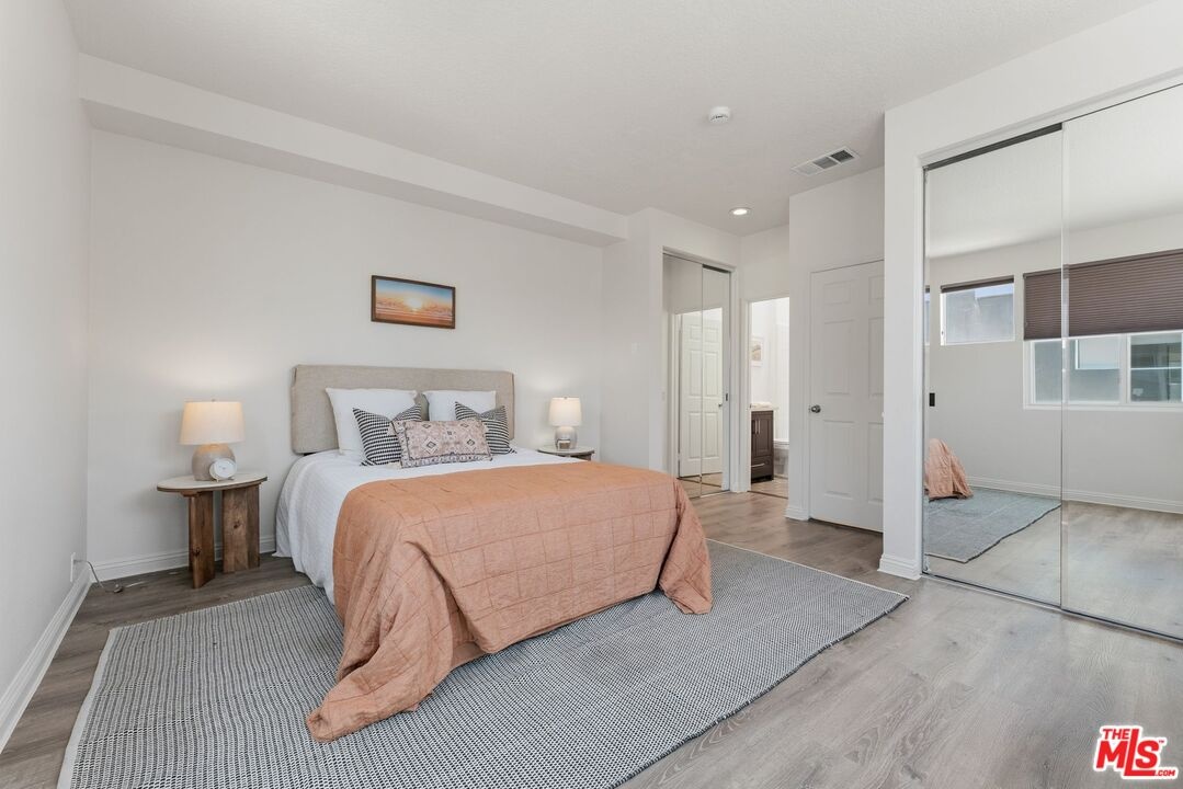 Bedroom featuring wood-style f