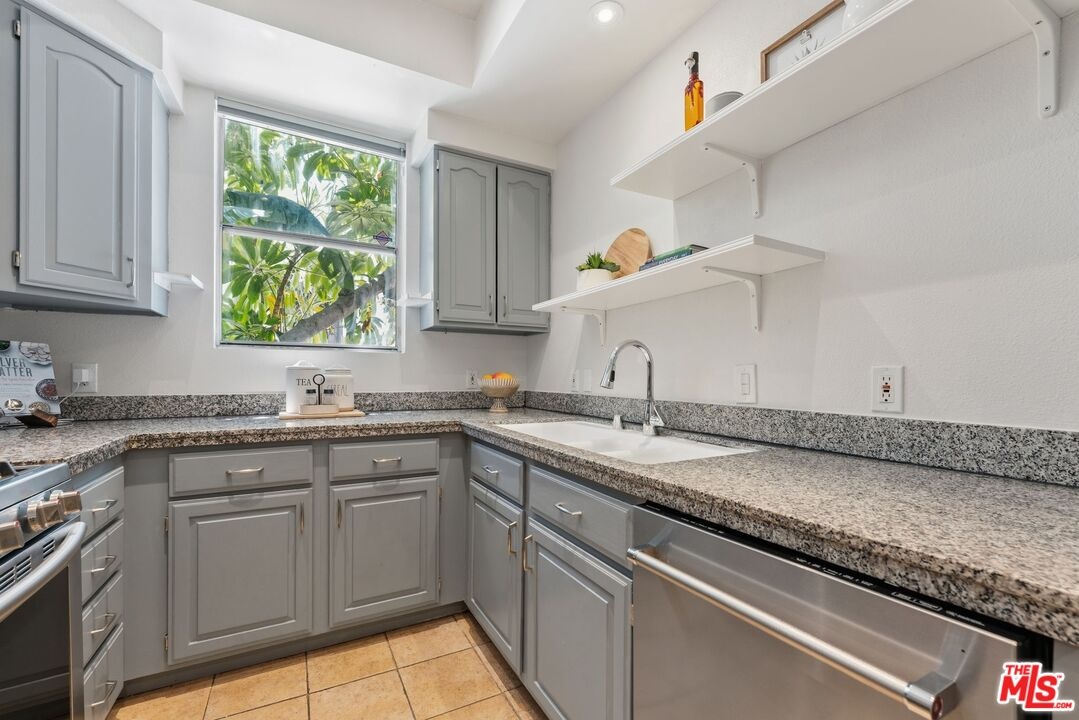 Kitchen featuring grey cabinet