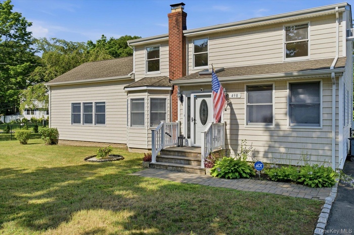 Paver walkways and slate steps leads you into this beautiful home.