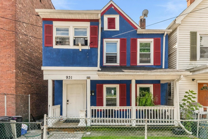 Two-story home with a blue facade and red shutters