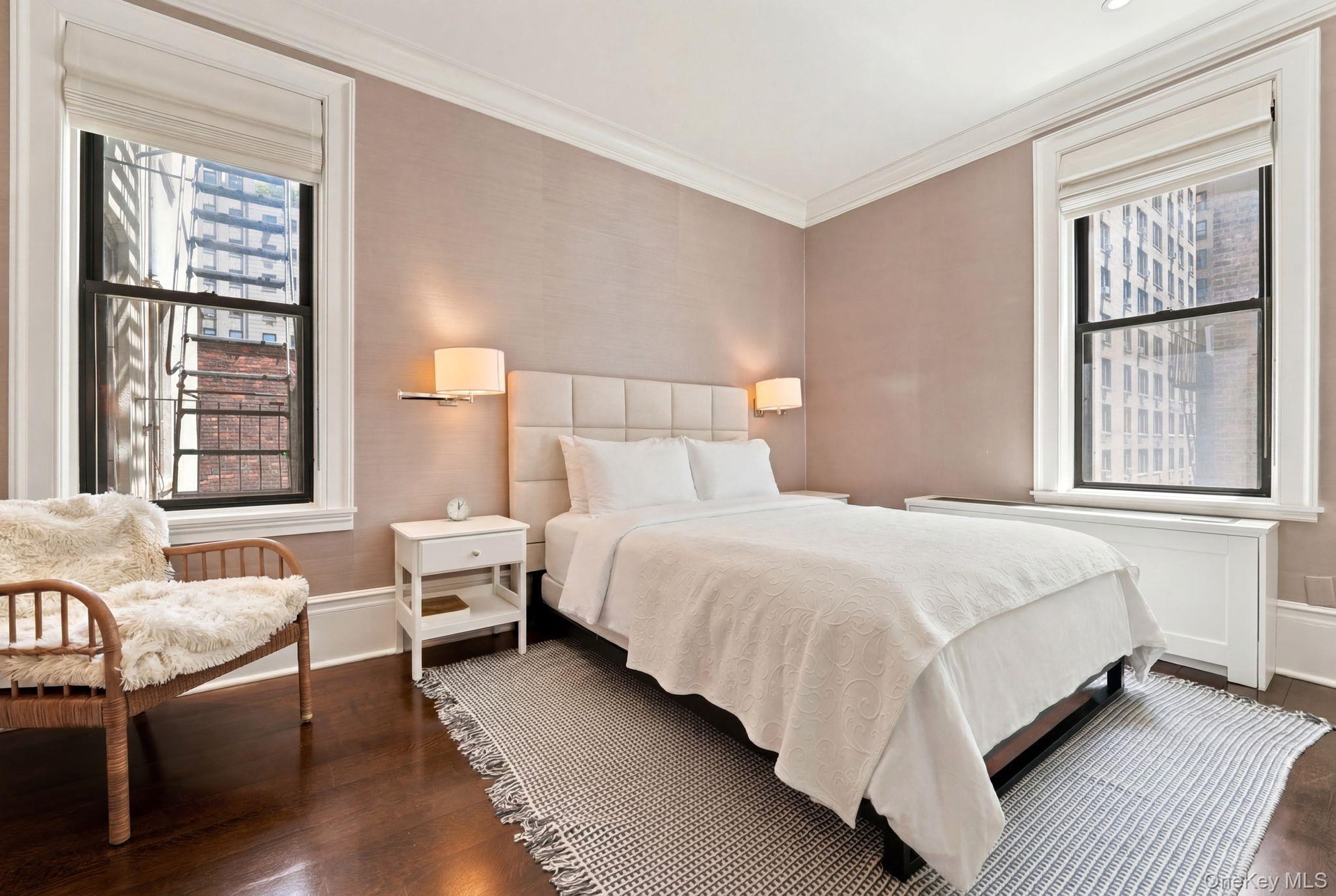 Room featuring dark wood-finish flooring, textured wall covering, and crown molding