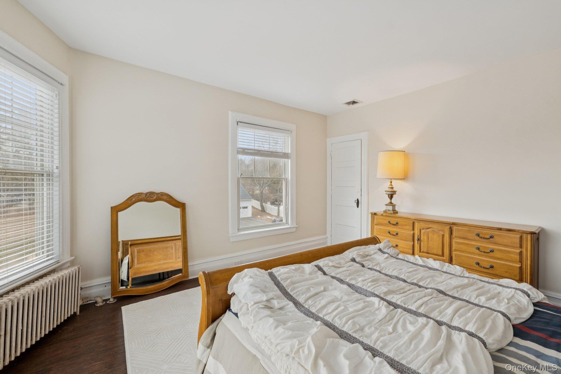 Bedroom featuring radiator heating unit and wood finished floors
