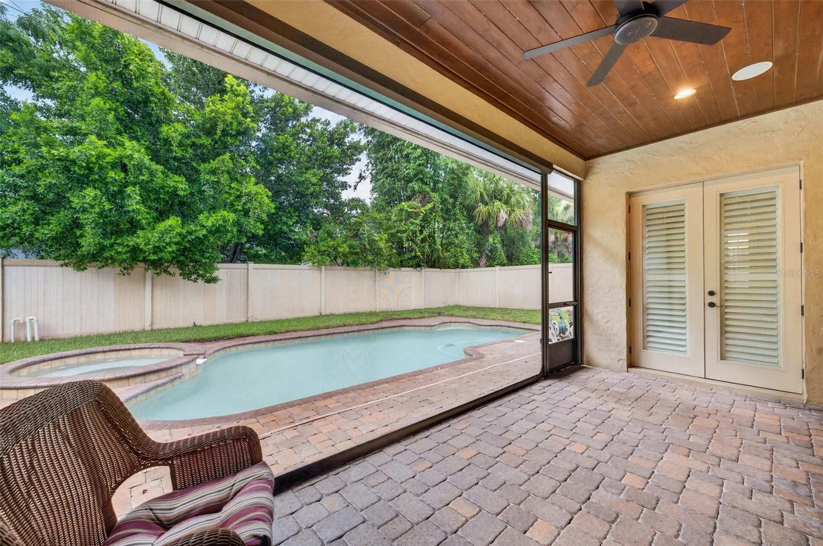 Private lanai with tongue & groove ceiling and remote screens