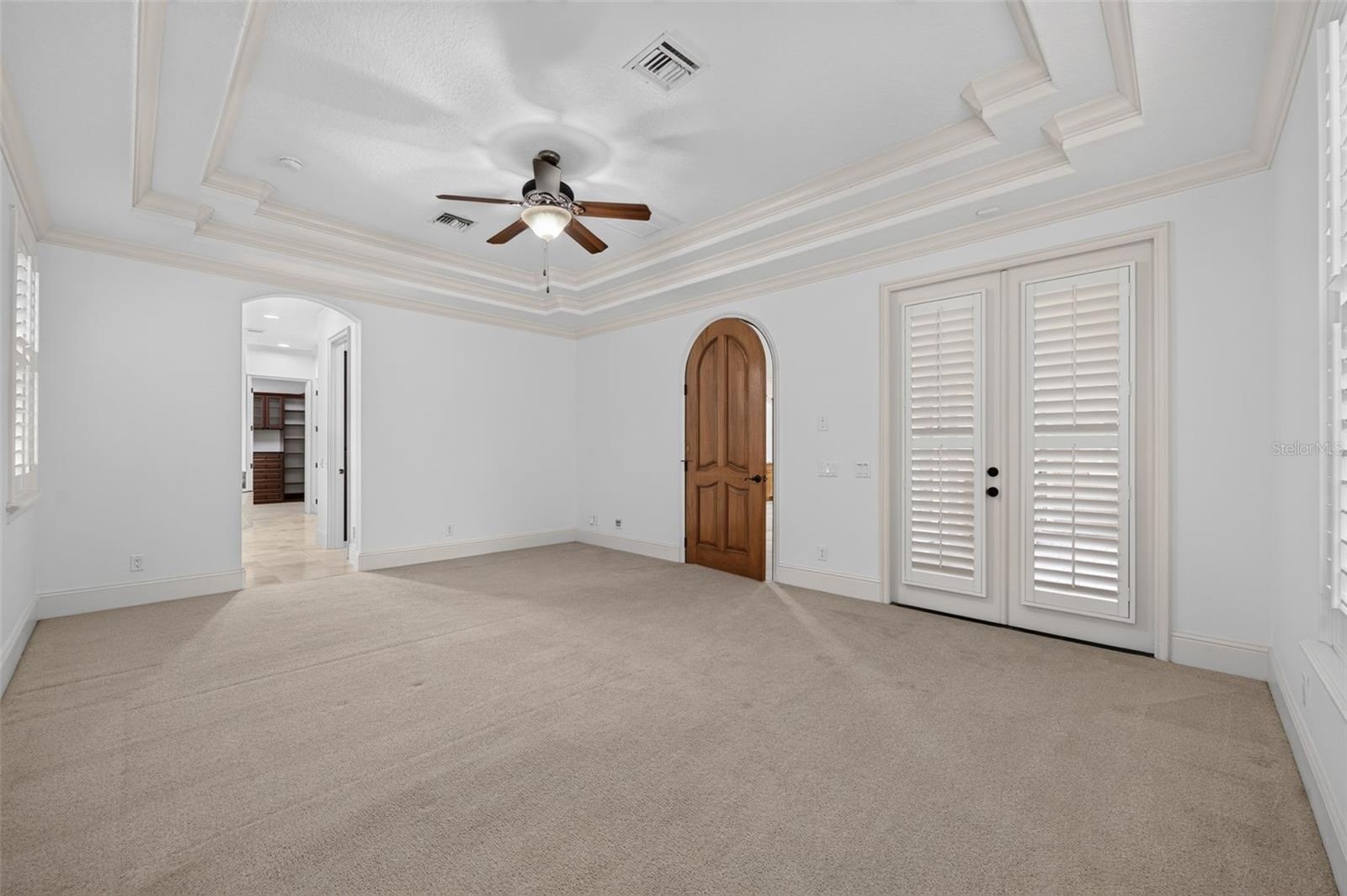 First Floor Primary Suite with French Doors opening to the lanai