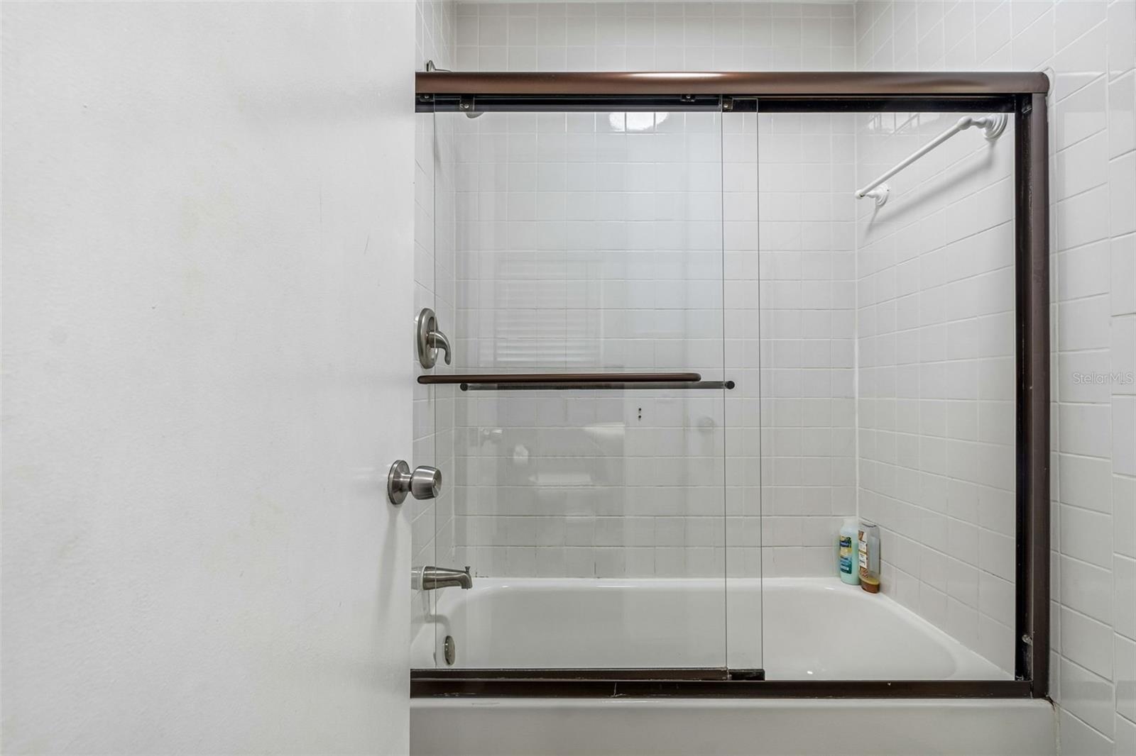 Shower/tub combination shared with the half bathroom in the hallway and bathroom off bedroom 3