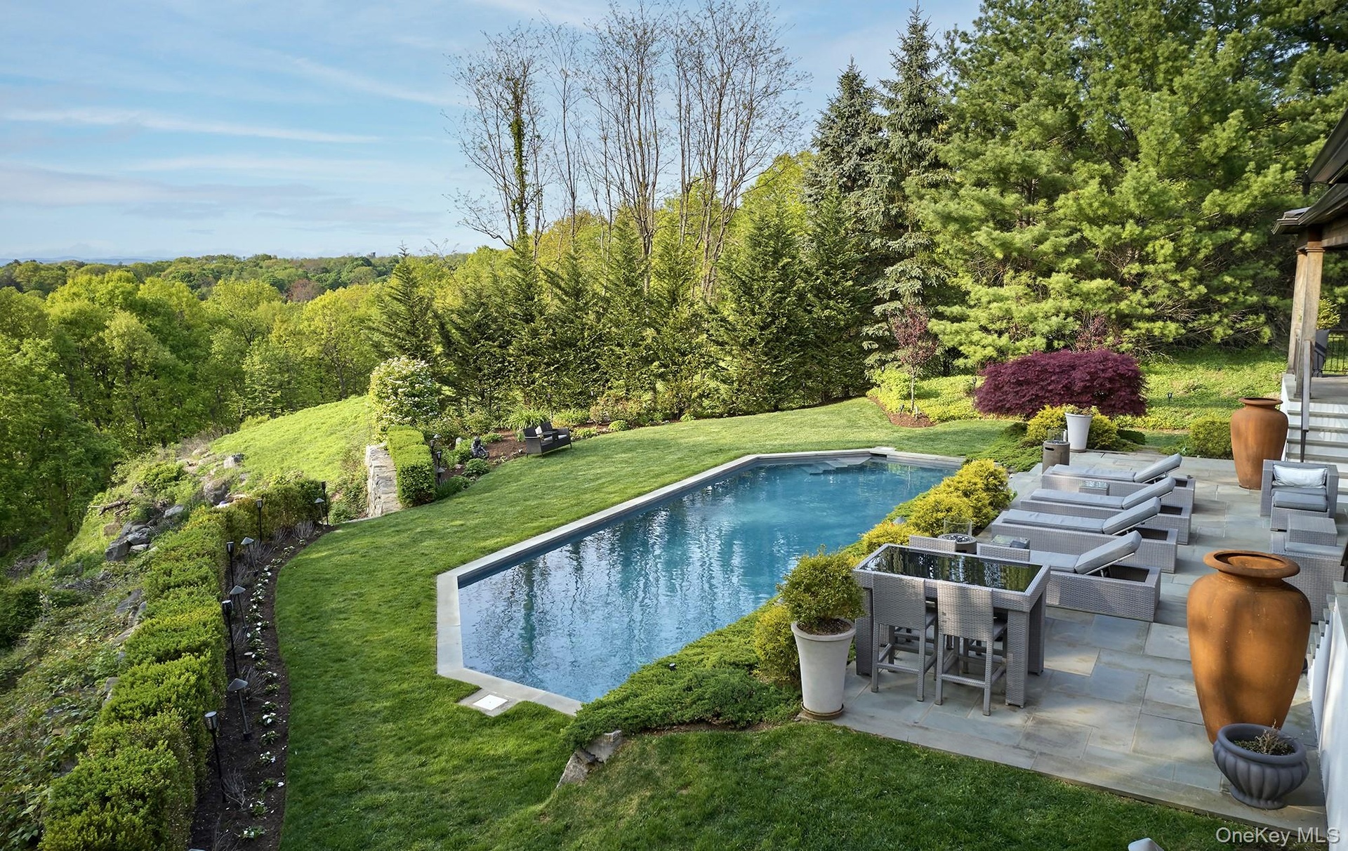 Rear landscaped garden with patio and salt water pool.