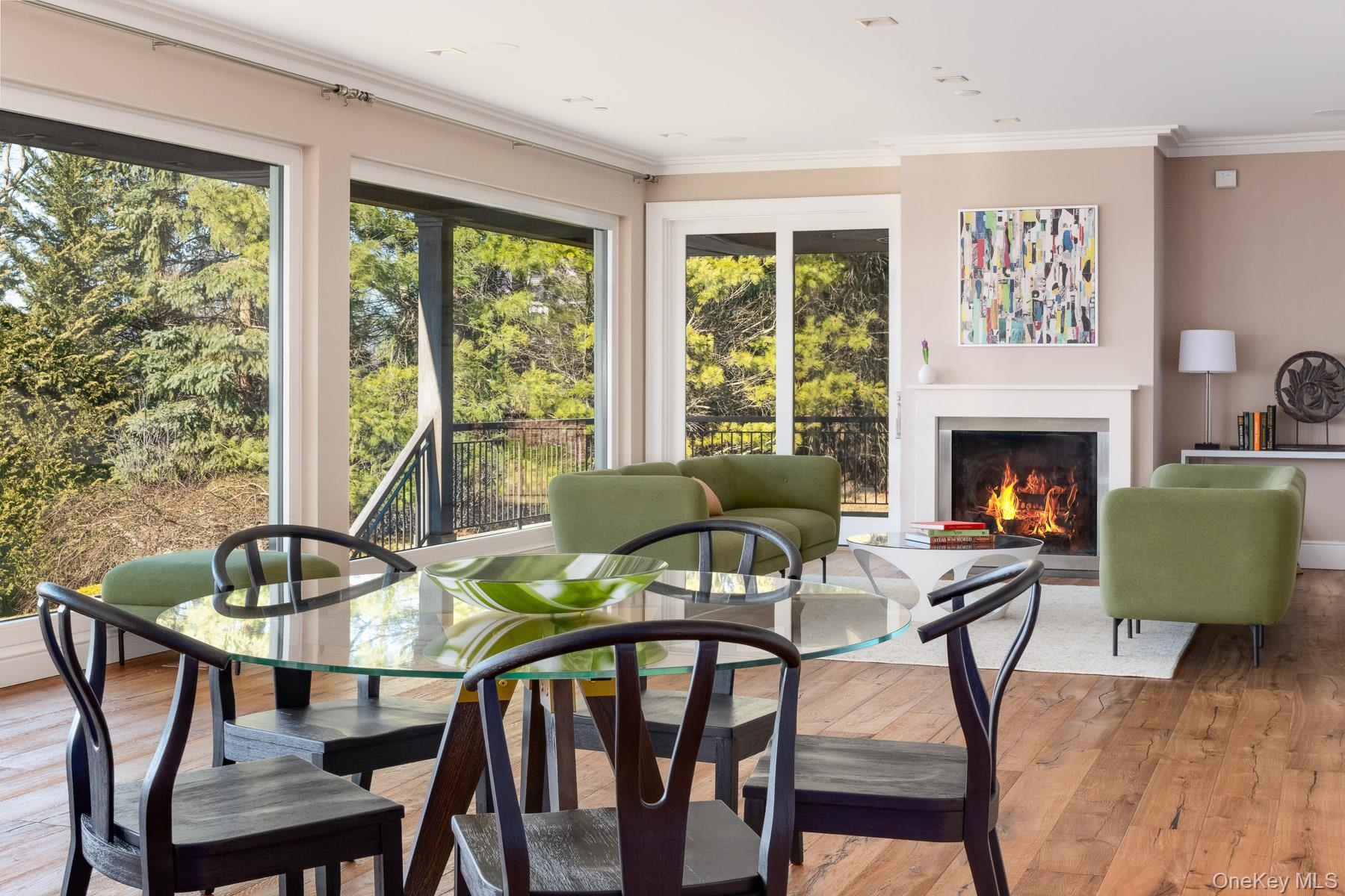 Open floor plan with dining area off large living room features gas fireplace.