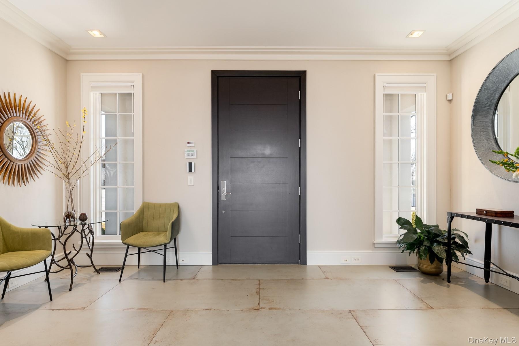 Elegant entry foyer enhanced with porcelain tile floors.