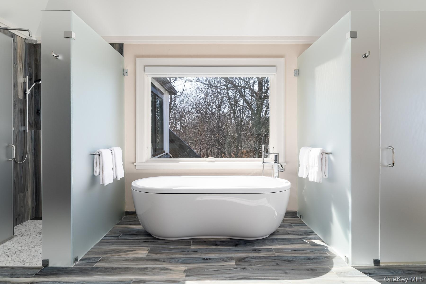Primary bathroom with soaking tub and radiant heated floors.
