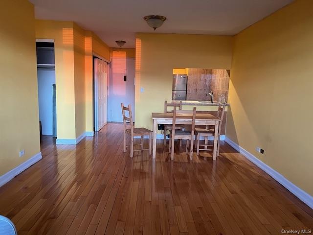 Dining area with sink and light wood-type flooring
