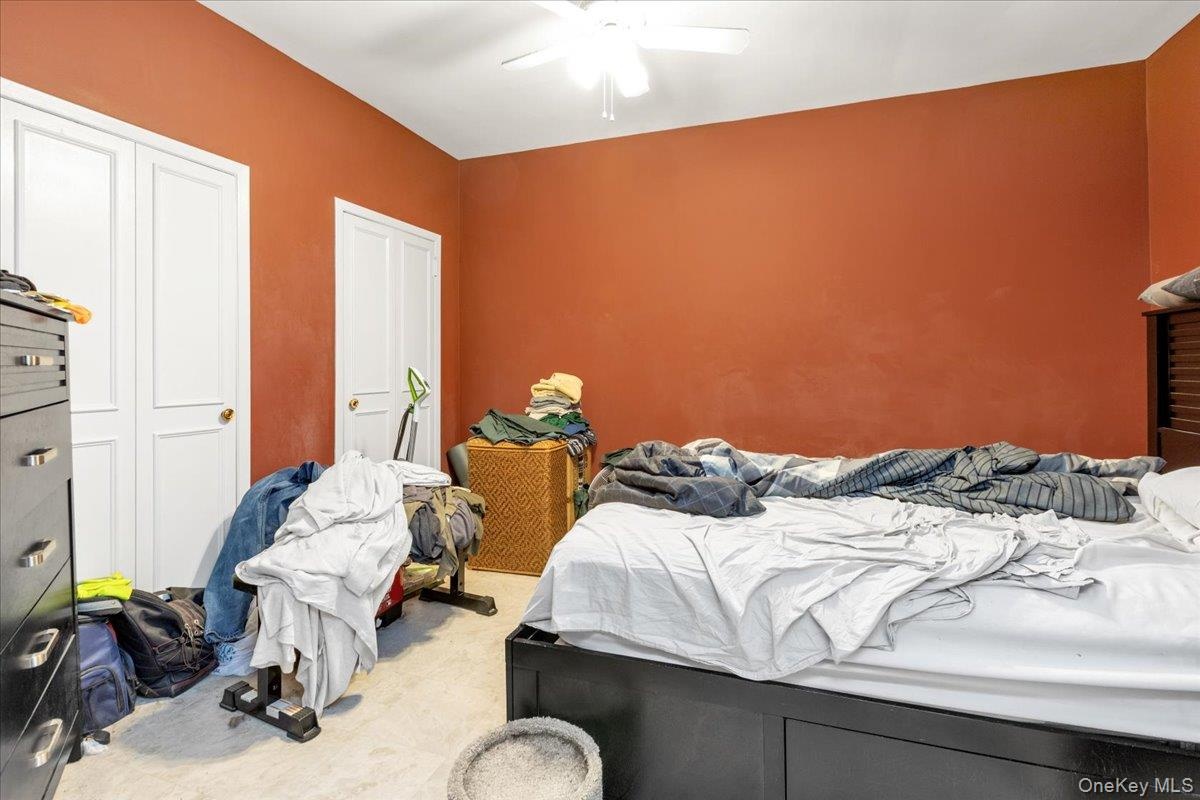 Bedroom with ceiling fan and carpet floors