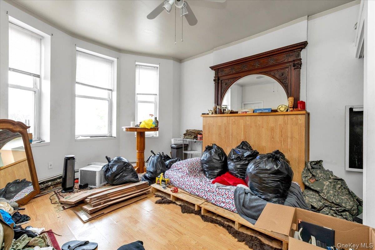 Bedroom with hardwood / wood-style flooring and ceiling fan