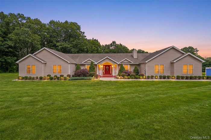 Single-story home featuring a broad front lawn