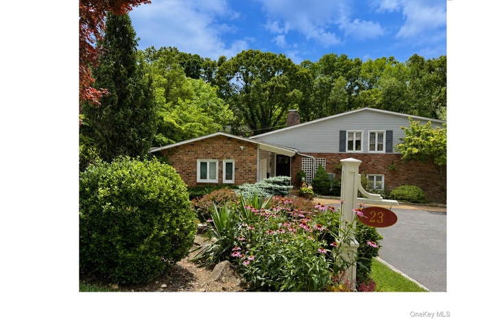 Lush front landscaping featuring varied plantings and blooming flowers