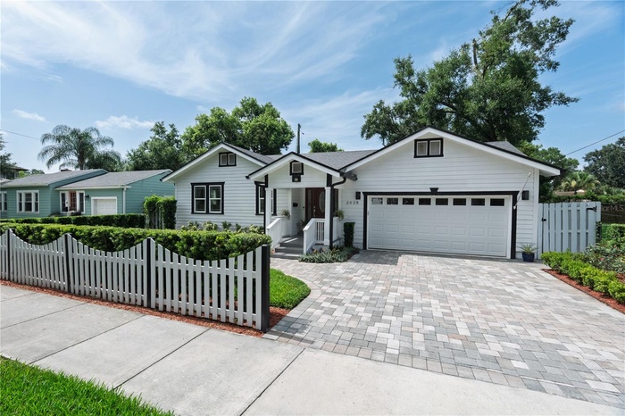White picket fence & attractive pavered drive