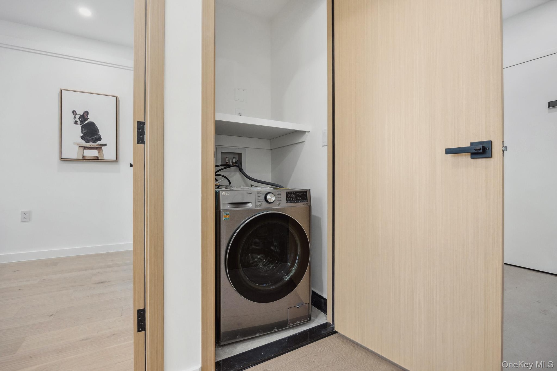 Washroom featuring washer / clothes dryer and light wood-style flooring
