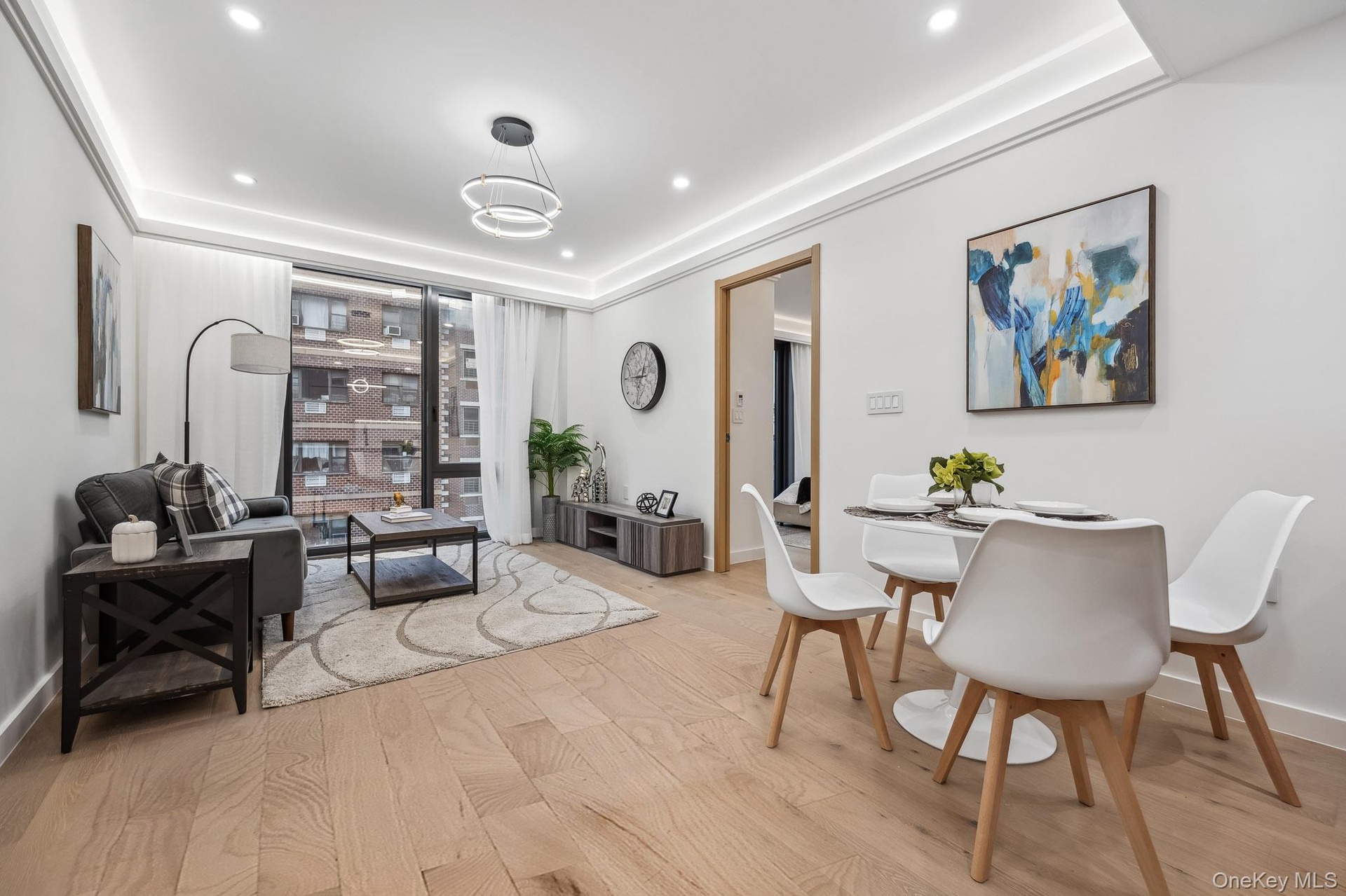 Dining area featuring light wood-style flooring, recessed lighting, a wall of windows, and baseboards