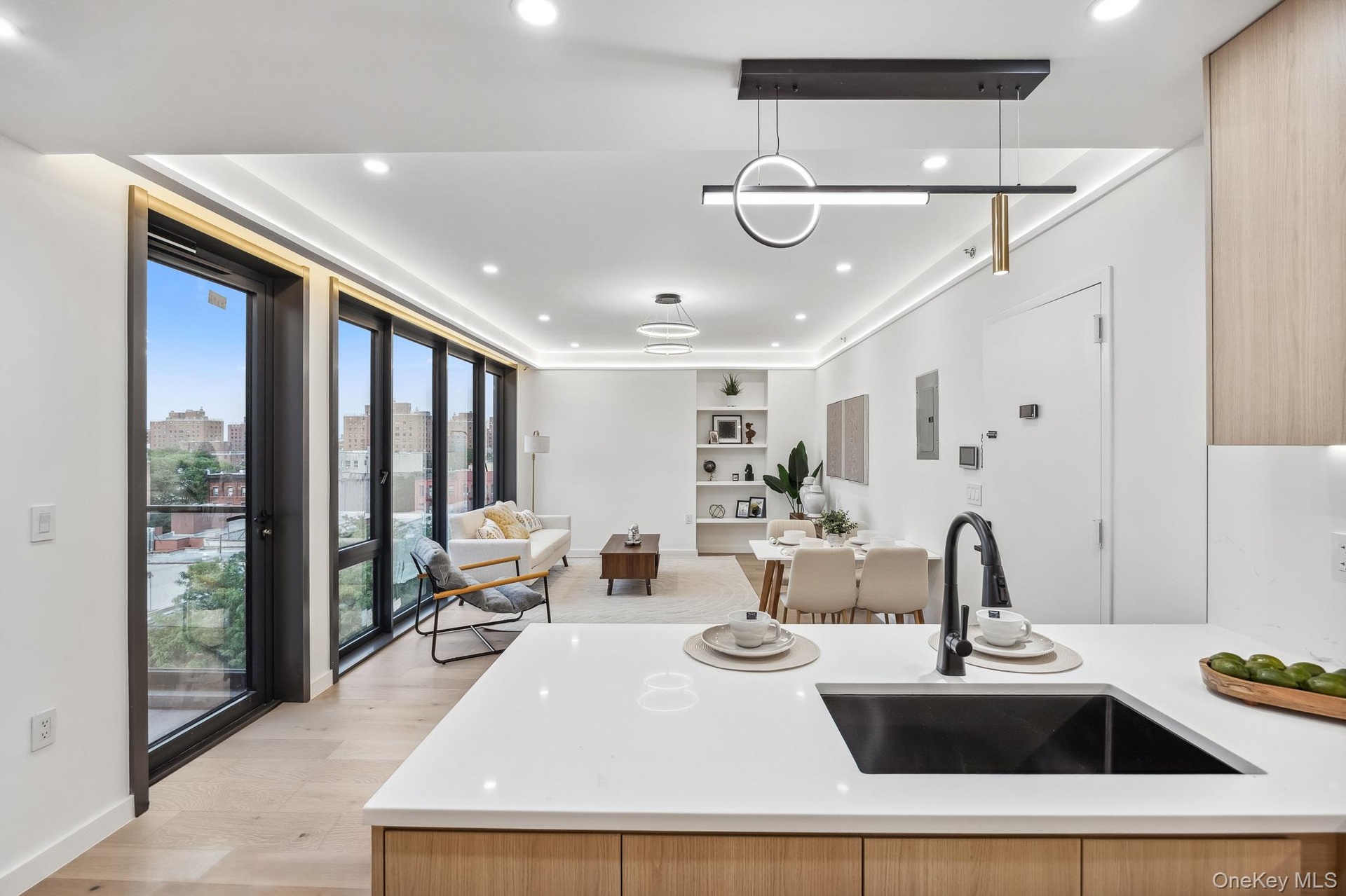 Kitchen with a sink, plenty of natural light, open floor plan, light countertops, and recessed lighting