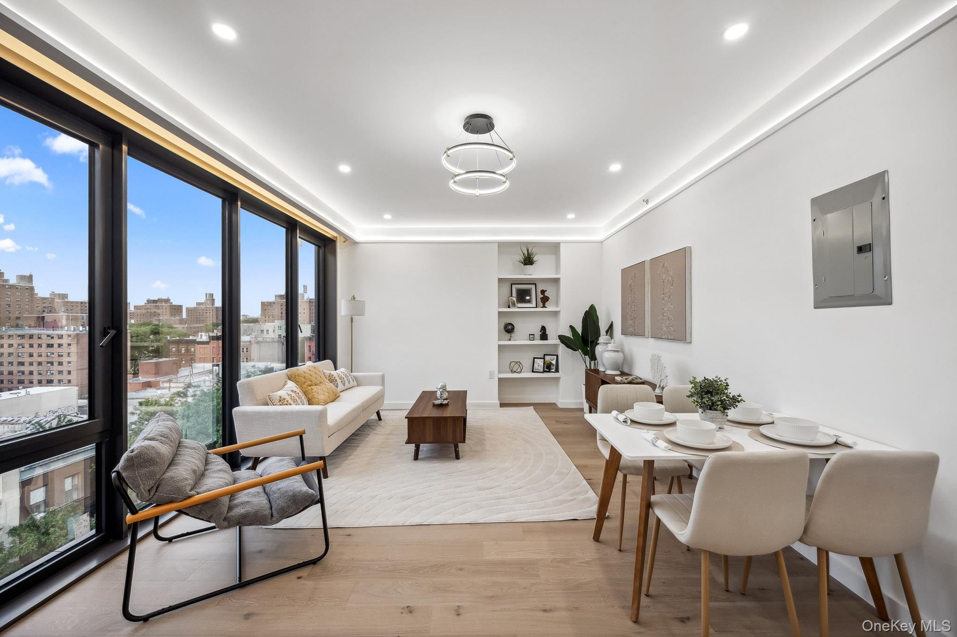 Dining space with electric panel, wood finished floors, a view of skyline, and recessed lighting