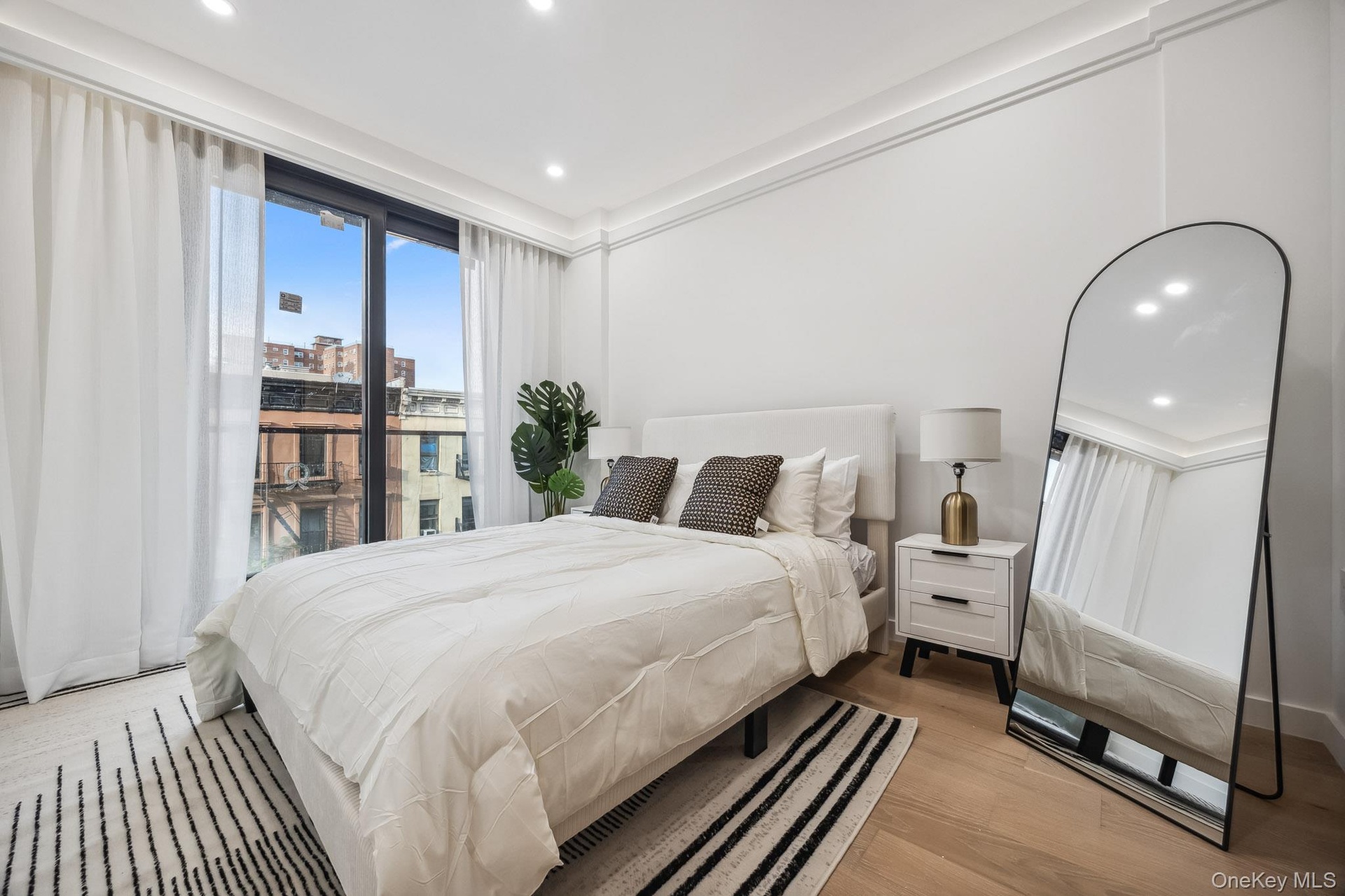 Bedroom with light wood-style flooring and recessed lighting