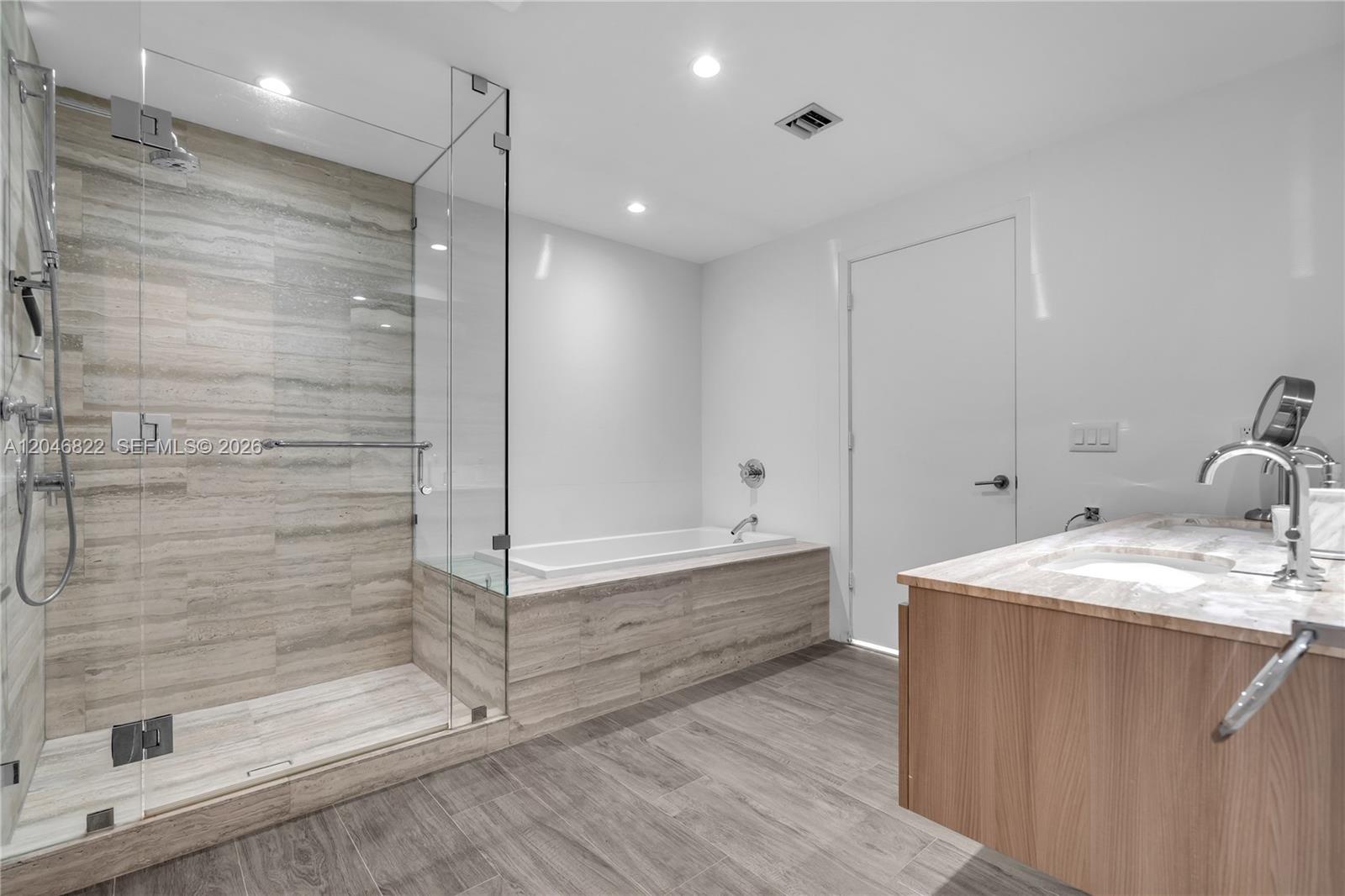 Private water closet with wood-look tile flooring