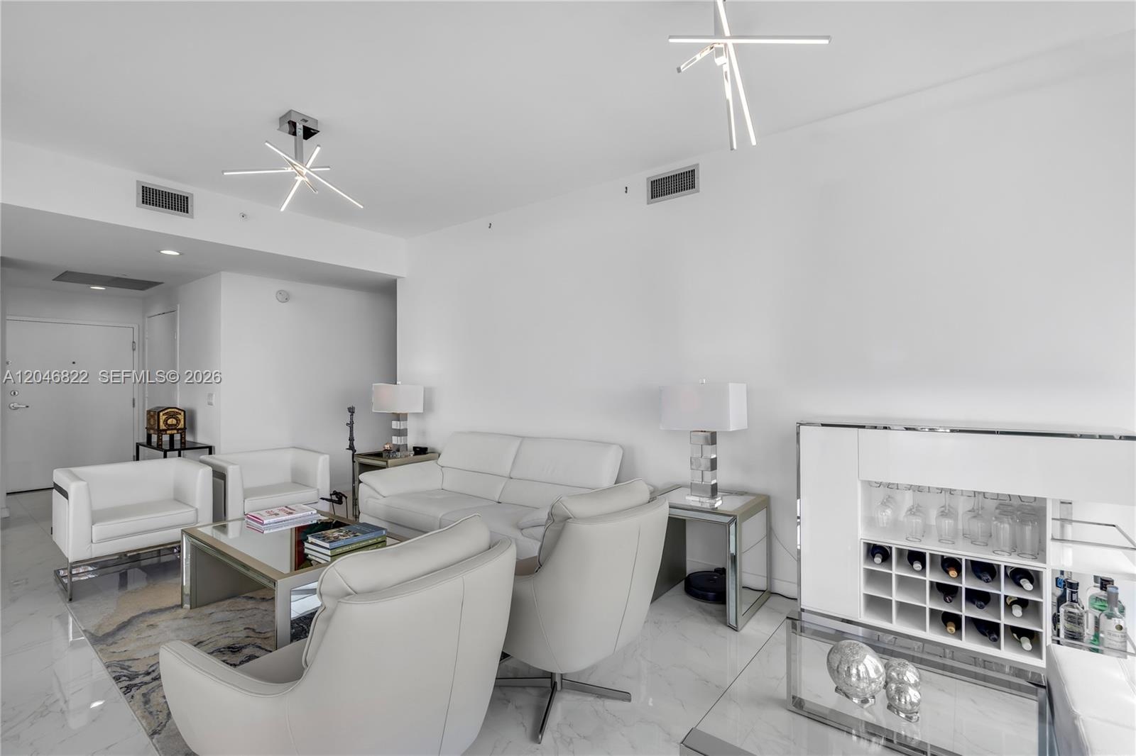 Furnished bedroom with floor-to-ceiling windows and bay views