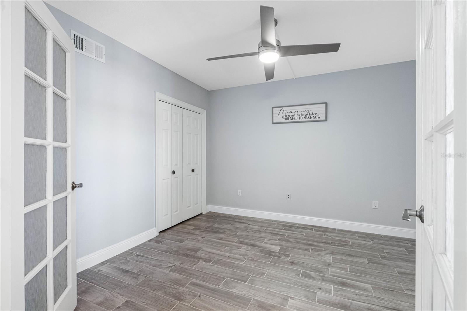 ... Main Floor Guest Bedroom #2 .. New Tile Floors - Closet and French Doors ..