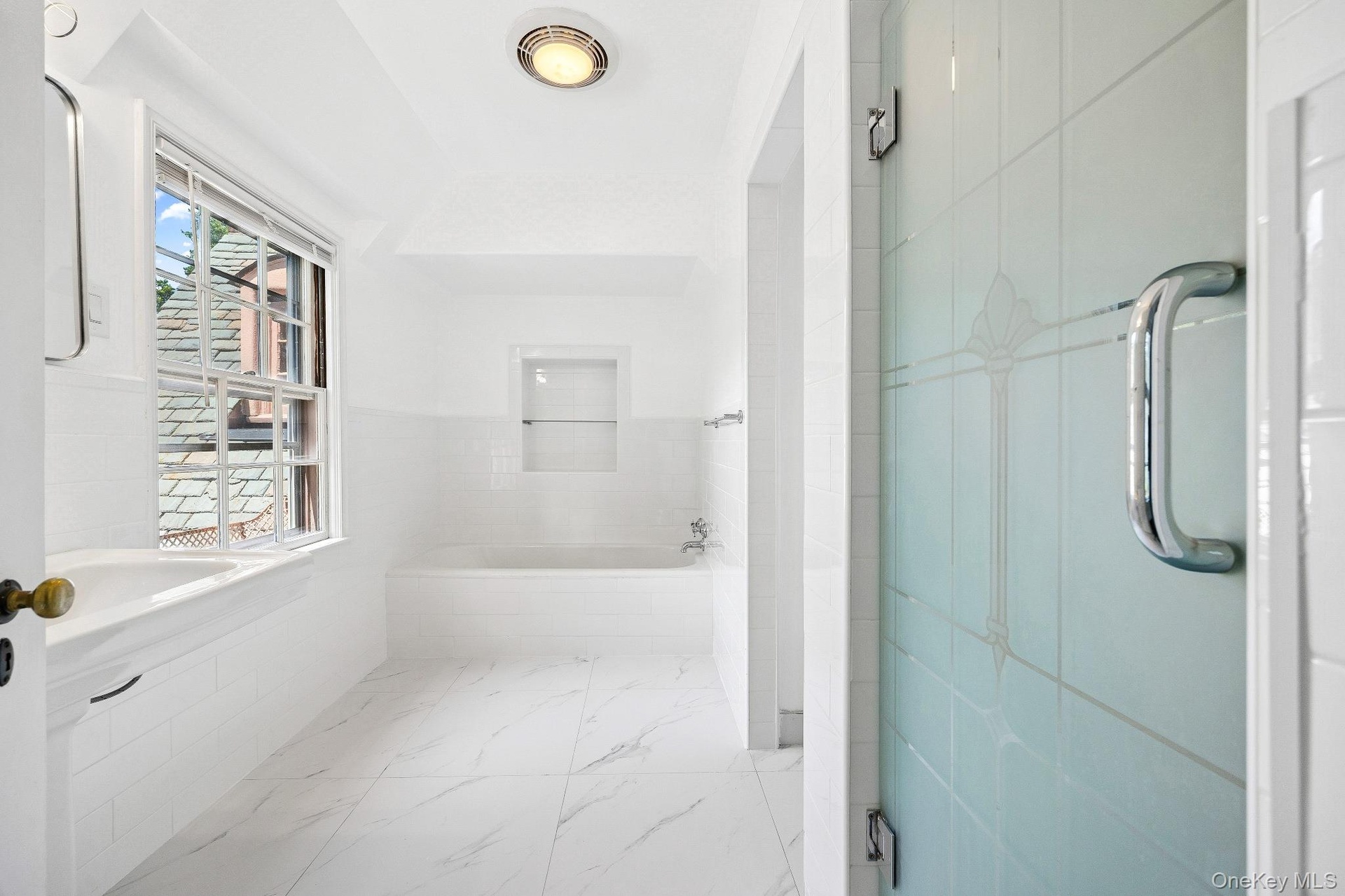 Bathroom with a bath and marble finish flooring
