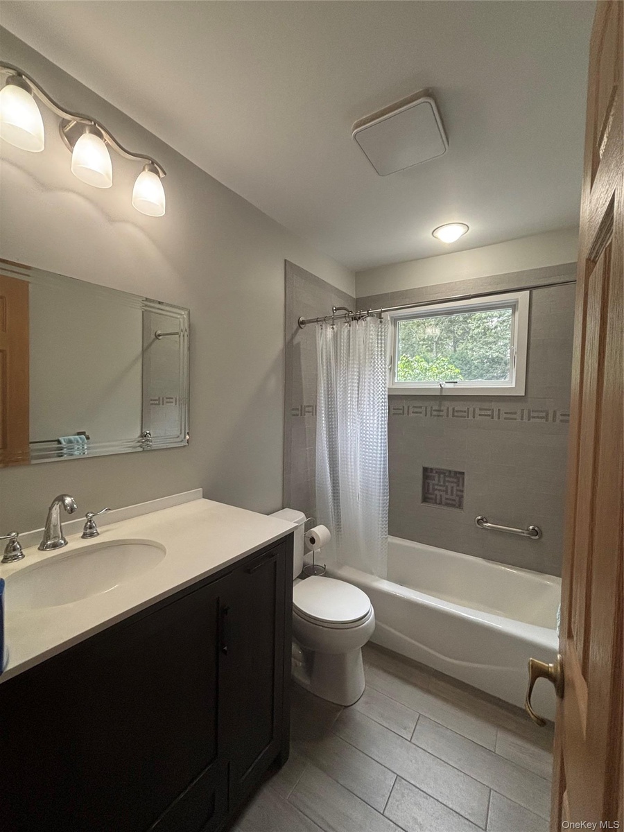 First Floor Bathroom.Newly tiled with a bathtub