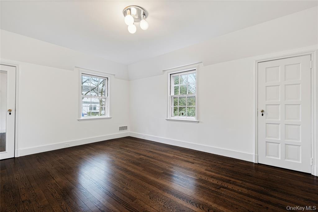 Second floor bedroom and dark wood-style floors