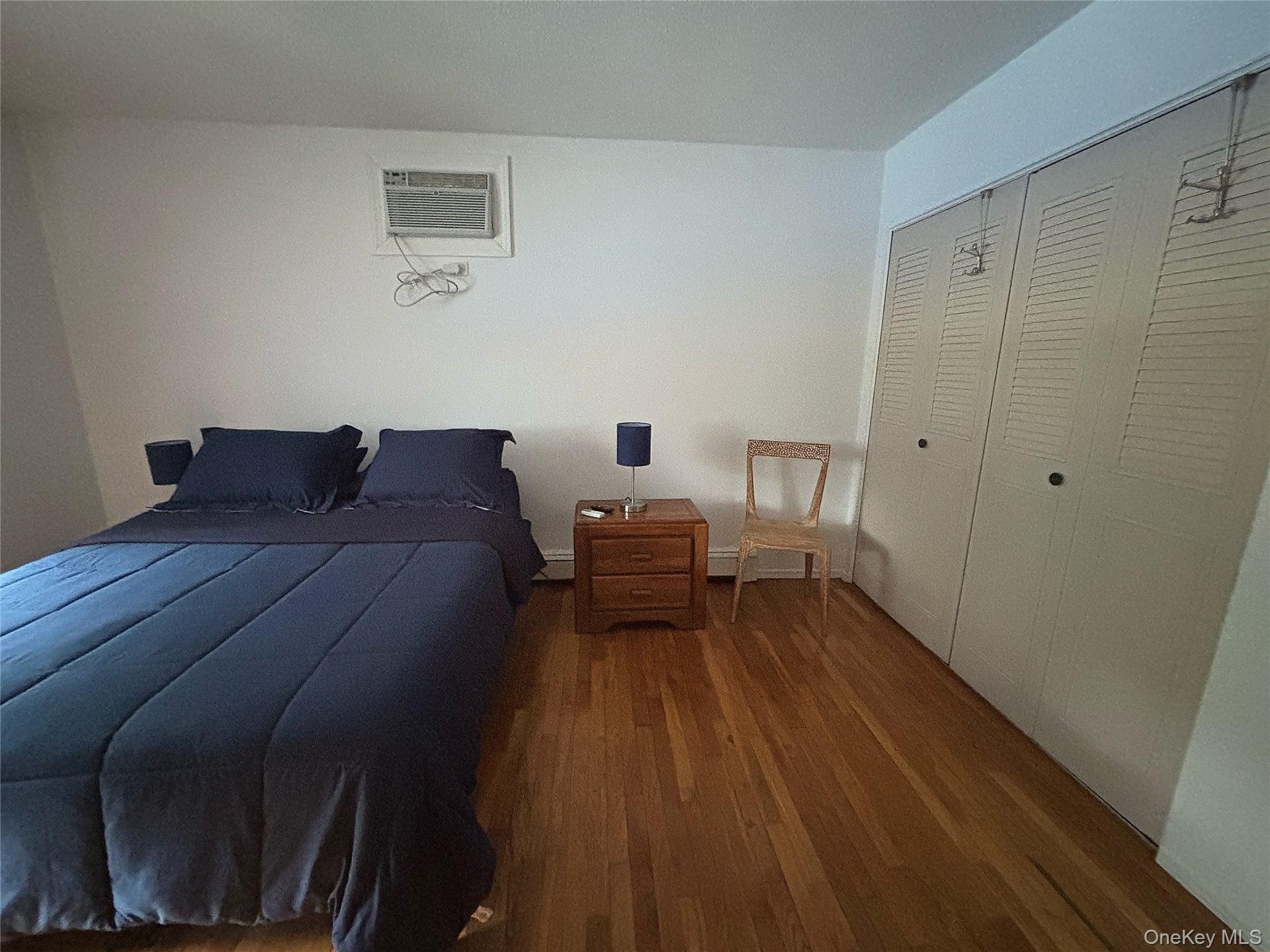 First Floor Bedroom #1  Queen size Bed, Closet, Dresser, Nightstand, Chair, A/c Wall unit.