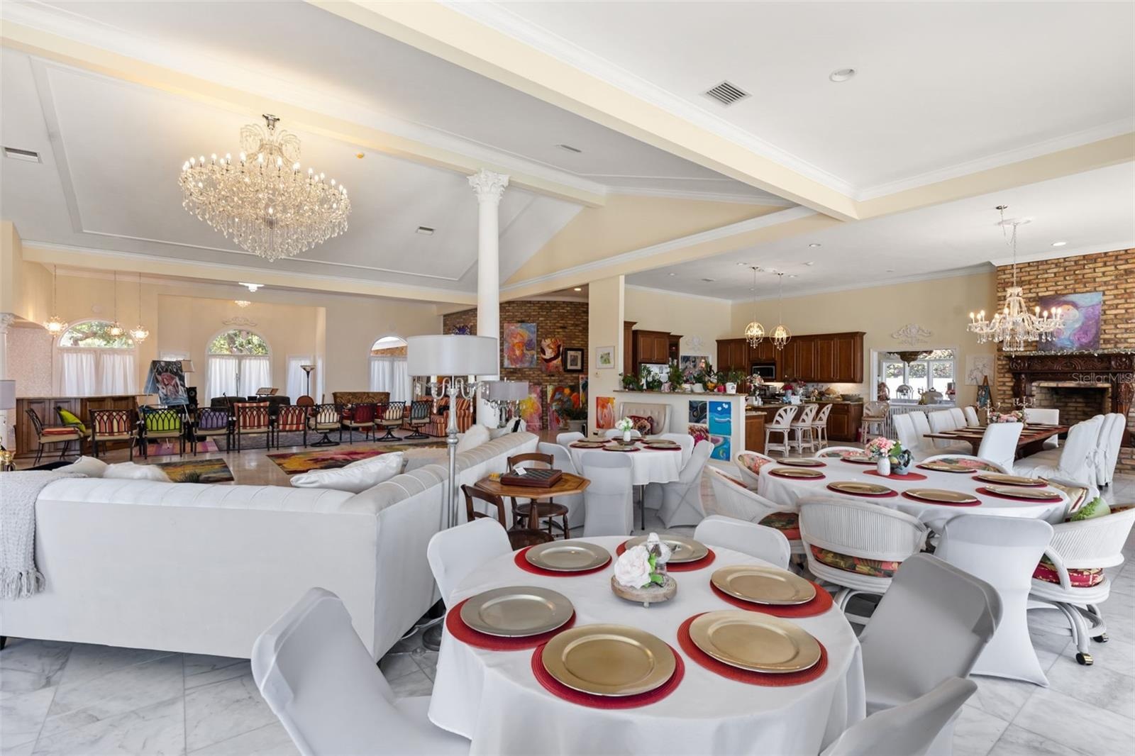 Grand living room flows effortlessly into the open floor plan, showcasing the home's scale and architecture elegance ideal for both entertaining and l