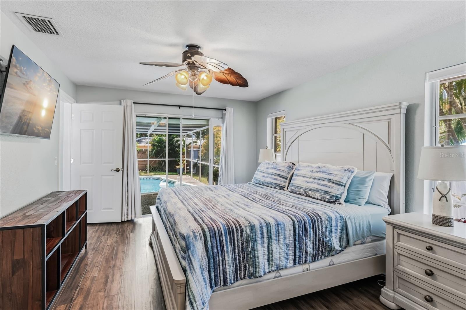 Main bedroom with sliding glass doors to the pool area