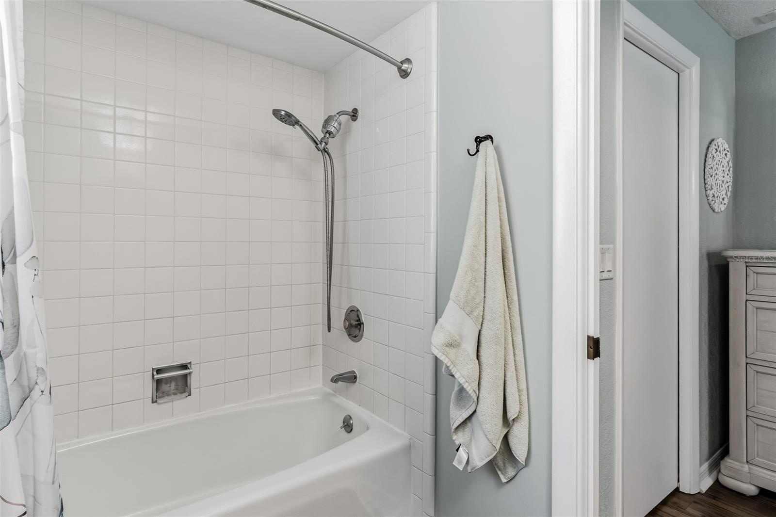 En-suite bathroom with shower/tub combo.