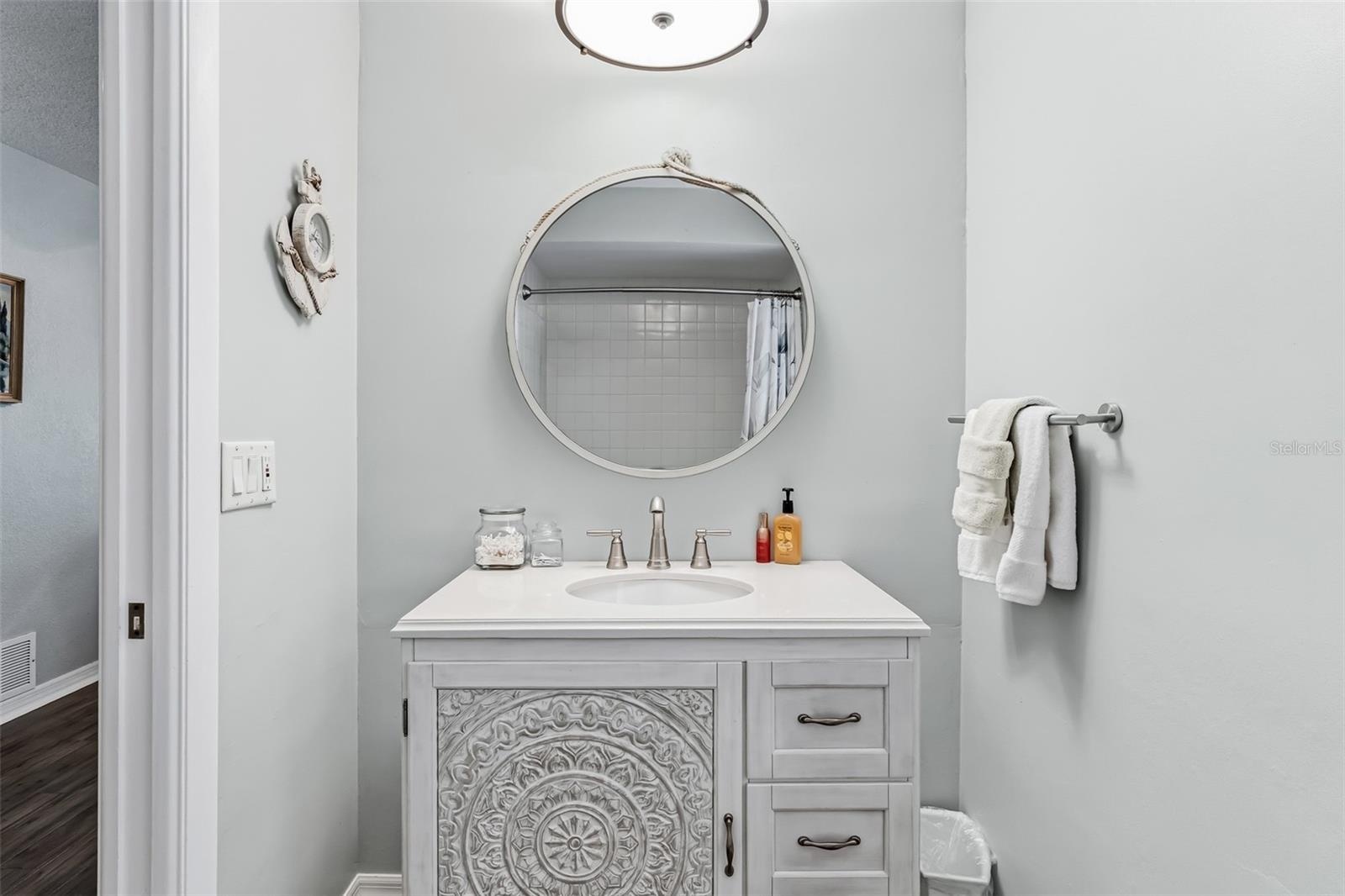 En-suite bathroom with newer vanity and shower/tub combo.