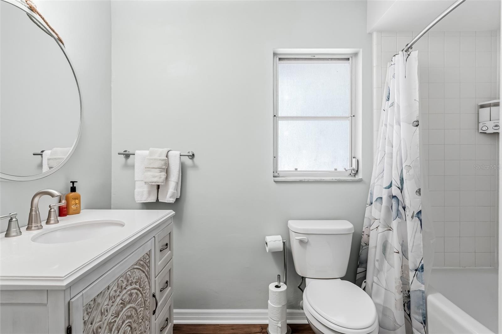 En-suite bathroom with newer vanity and shower/tub combo.