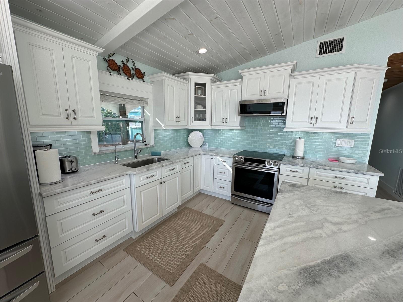 A spacious, bright, and functional kitchen with a view that is unrivaled.