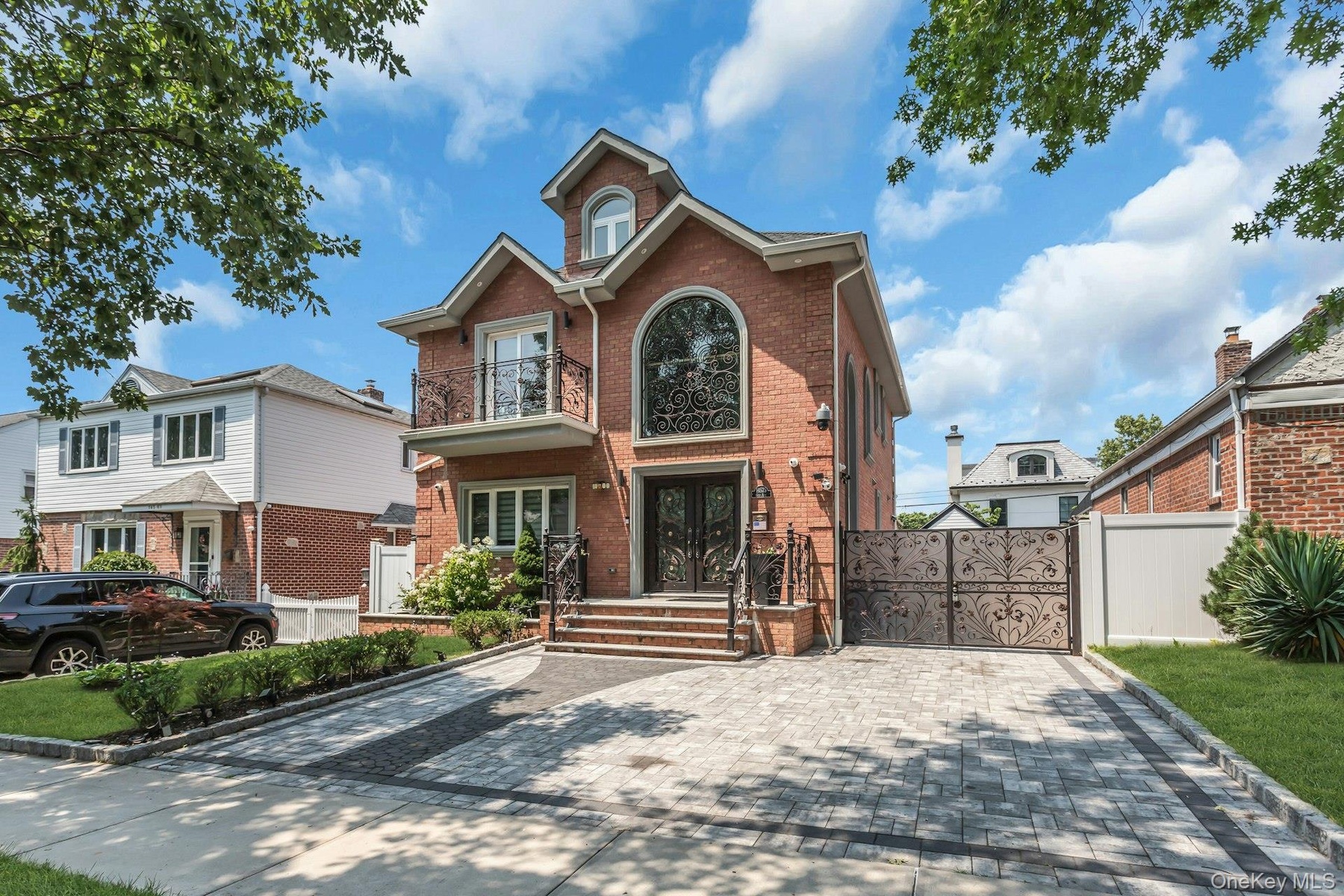 Featuring a full 2-car paver driveway, and professionally manicured landscaping wth inground sprinklers