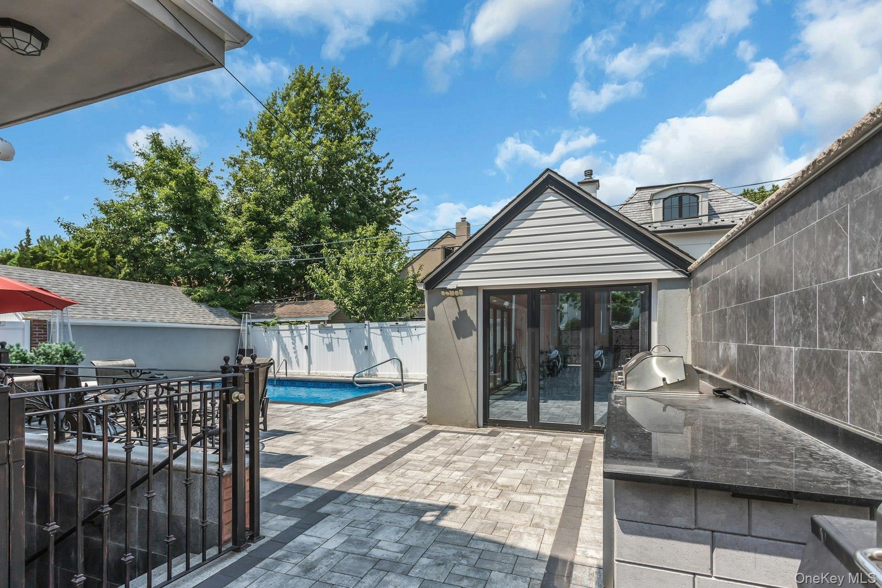Converted garage, easy to convert back. Finished tile floor, folding glass doors, sub panel electic service