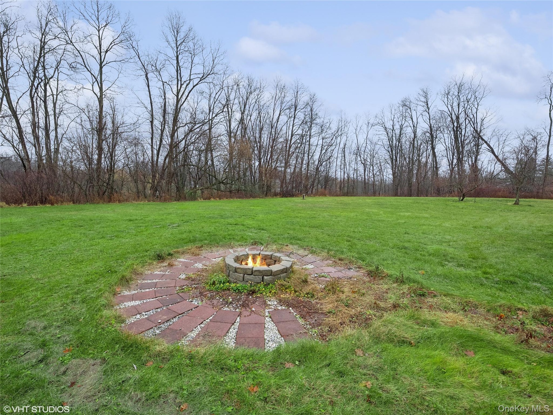 View of yard featuring an outdoor fire pit