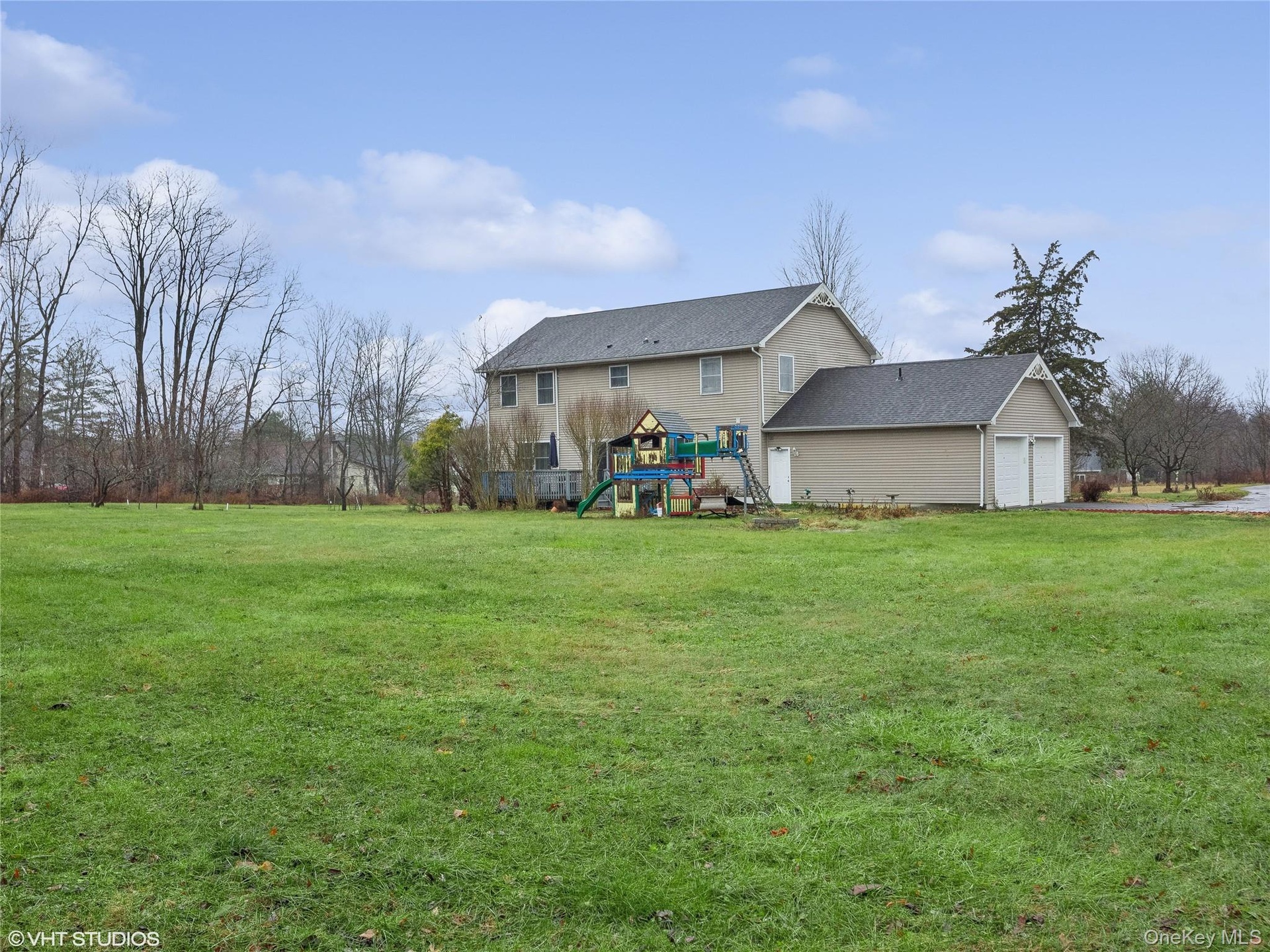 View of yard with a playground and a garage