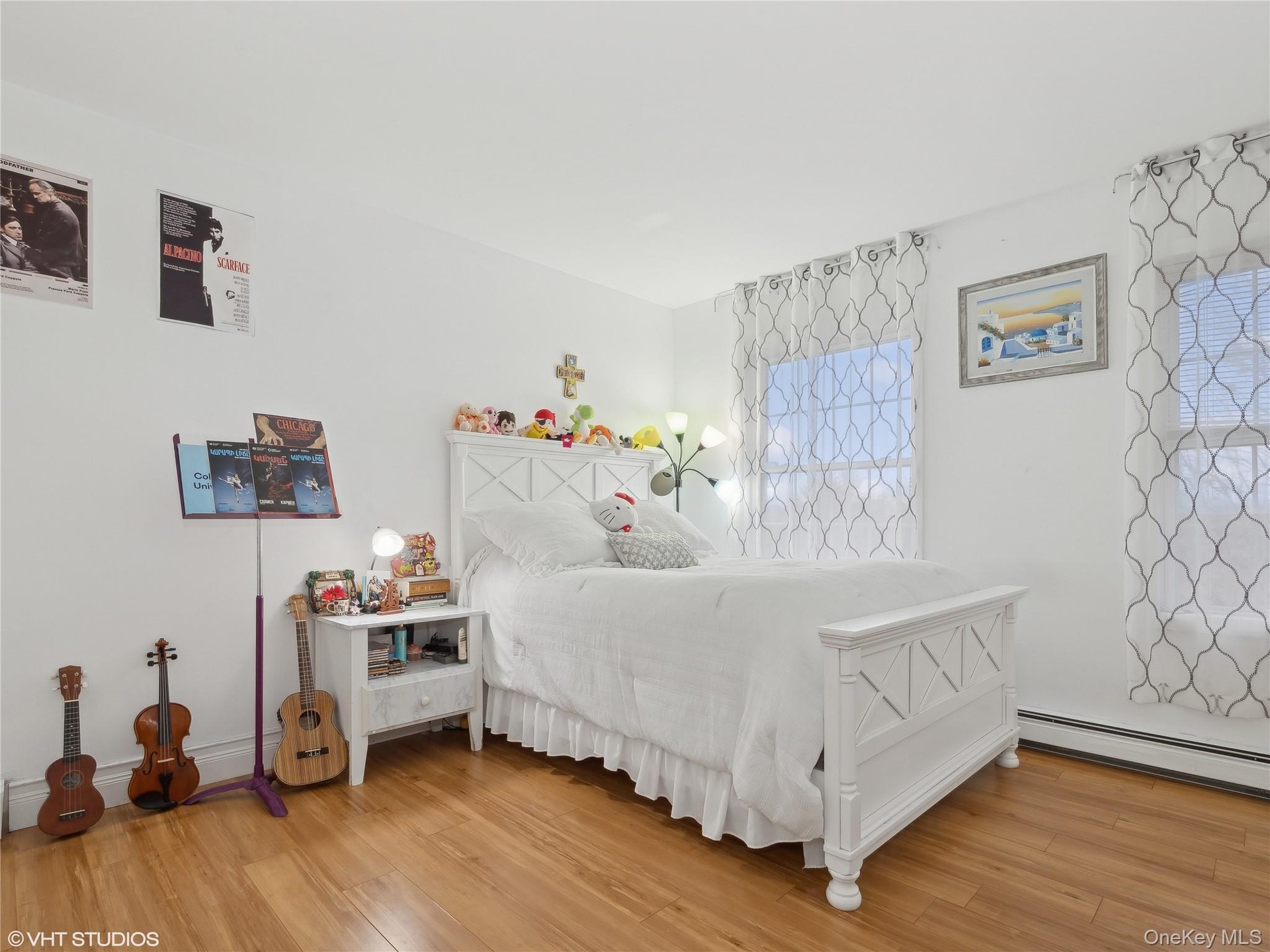 Bedroom featuring wood-type flooring and a baseboard radiator