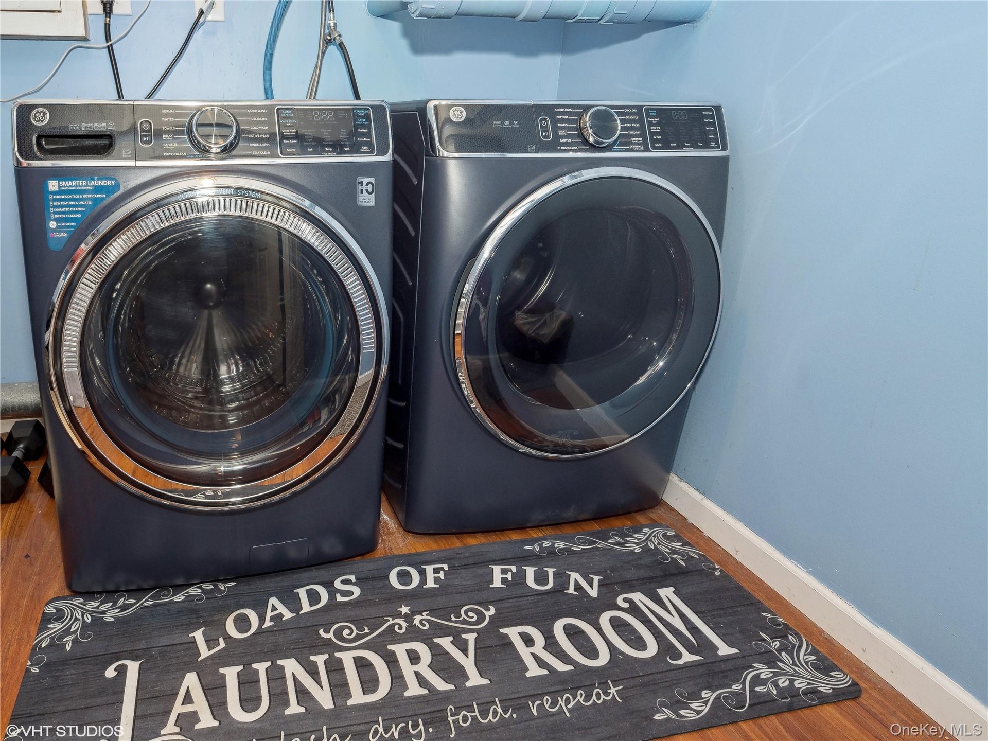 Laundry area featuring separate washer and dryer and hardwood / wood-style flooring
