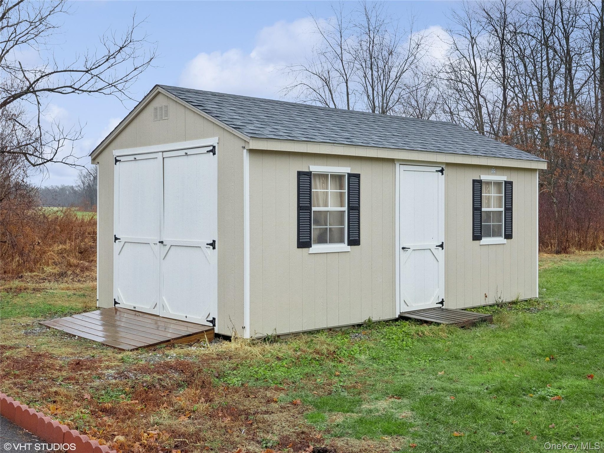 View of outdoor structure with a lawn