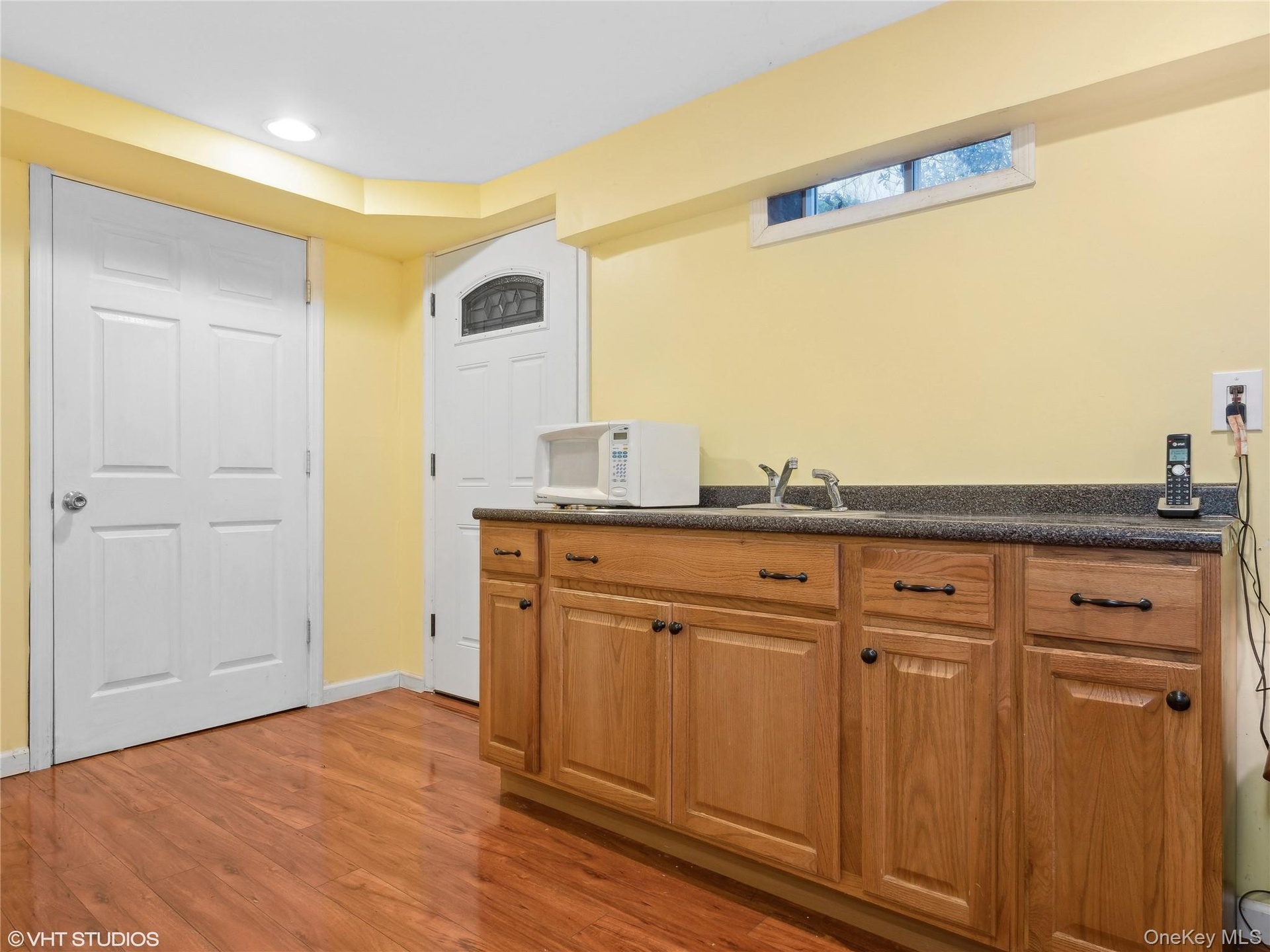 Kitchen with sink and wood-type flooring