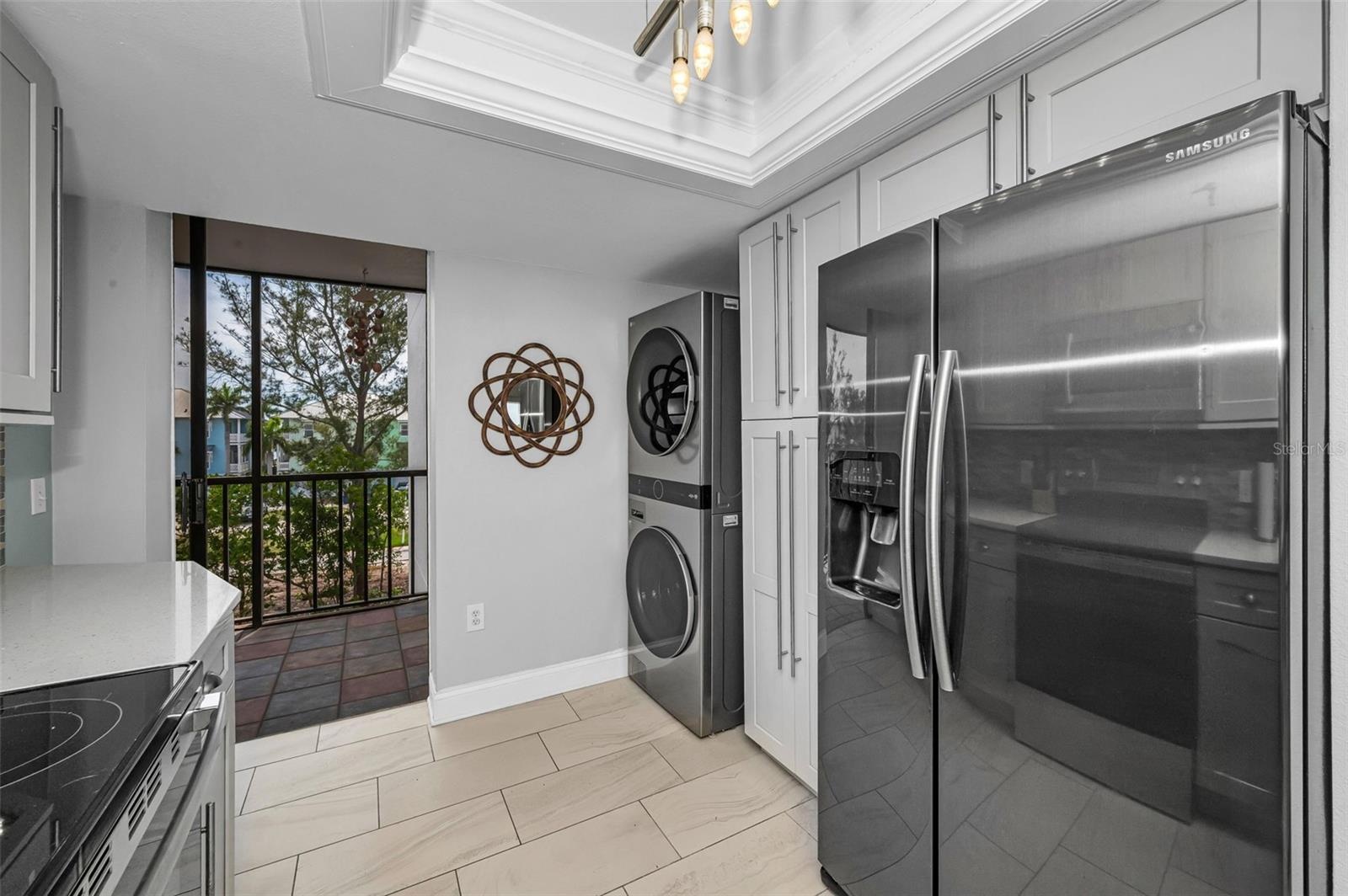 Other view showing the inside washer & dryer and slider to the west facing balcony