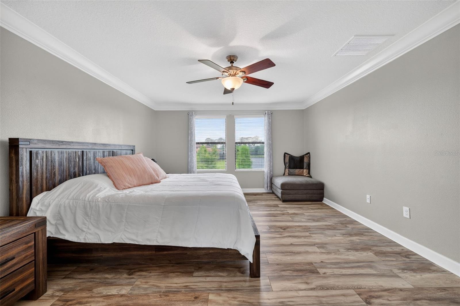 Primary Suite with LVP Floors, Crown Molding, Ceiling Fan, En-Suite Primary Bathroom, Windows Overlooking the View in Waterleaf Community! Enough Room