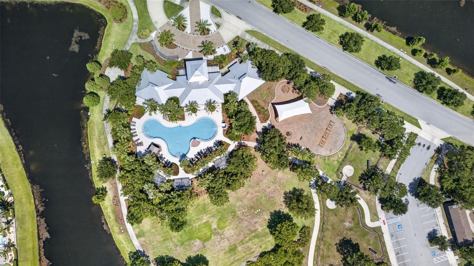 Aerial View of Amenities with Clubhouse, Resort Style Pool, Playground/Park, Sports Court, Dog Park, Walking Trails and Water View in Waterleaf Commun
