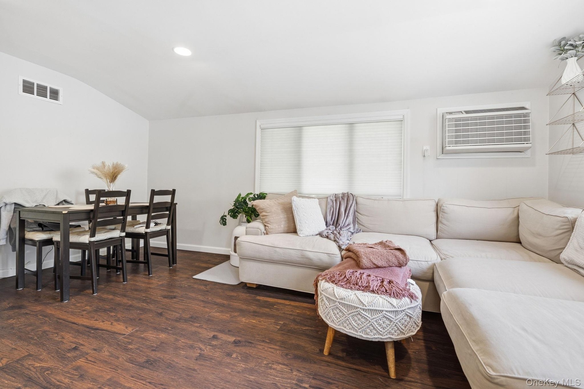 A bright and comfortable second-floor apartment living room with an integrated dining area, offering an easy, open flow for everyday living.